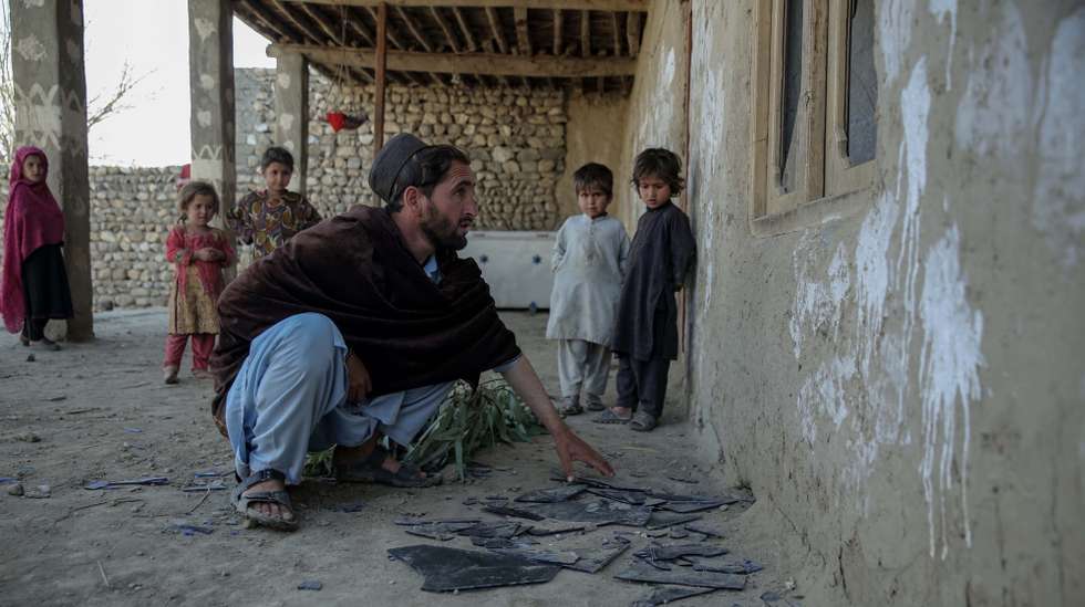 epa12787688 A local resident checks damage to a house after alleged overnight Pakistani airstrikes, in the Ghani Khel district of Nangarhar province, Afghanistan, 01 March 2026. Afghanistan has requested dialogue with Pakistan following days of intense military escalation triggered by a Taliban ground offensive in response to Pakistani airstrikes.  EPA/SAMIULLAH POPAL
