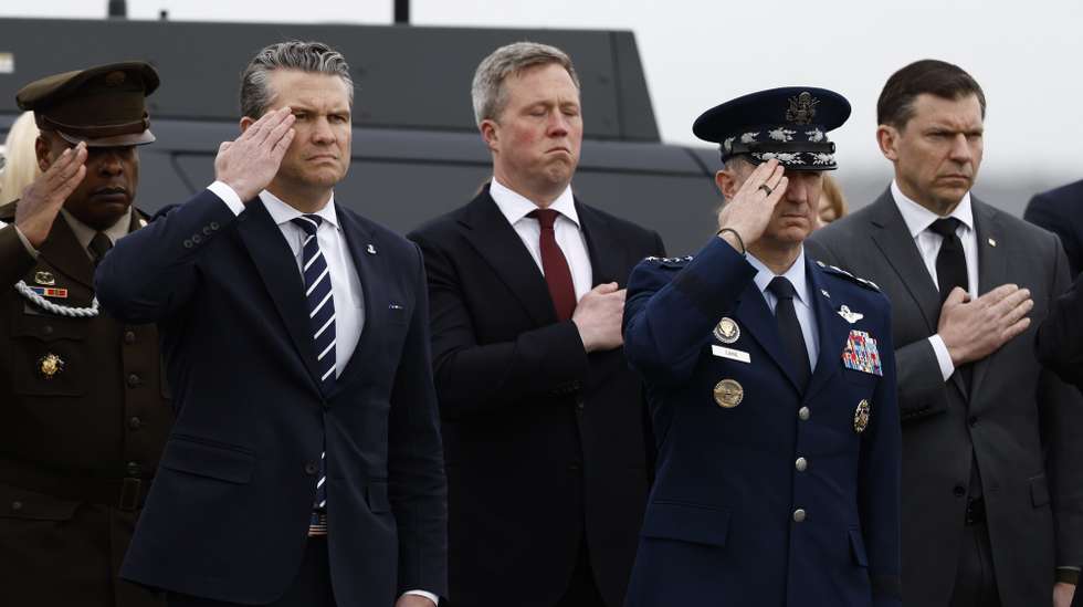 epa12802369 US Secetary of Defense Pete Hegseth (L) and US Chief of Staff Dan Caine (R) salute during the dignified transfer of six fallen US service members, at Dover Air Force Base in Dover, Delaware, USA, 07 March 2026. The remains of the soldiers from the 103rd Sustainment Command are being returned to the United States after they were killed in a drone attack in Kuwait.  EPA/WILL OLIVER