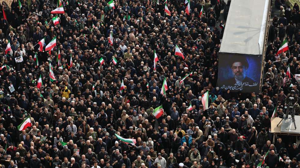 epa12812387 Iranians gather next to a poster of Iranian new supreme leader Ayatollah Mojtaba Khamenei as they take part during a massive funeral ceremonies for the Iran's Revolutionary Guards Corps (IRGC) commanders, army commanders and others victims who were killed during Iran-US and Israel war in Tehran, Iran, 11 March 2026. A joint Israeli and US military operation continues to target multiple locations across Iran since the early hours of 28 February 2026.  EPA/ABEDIN TAHERKENAREH