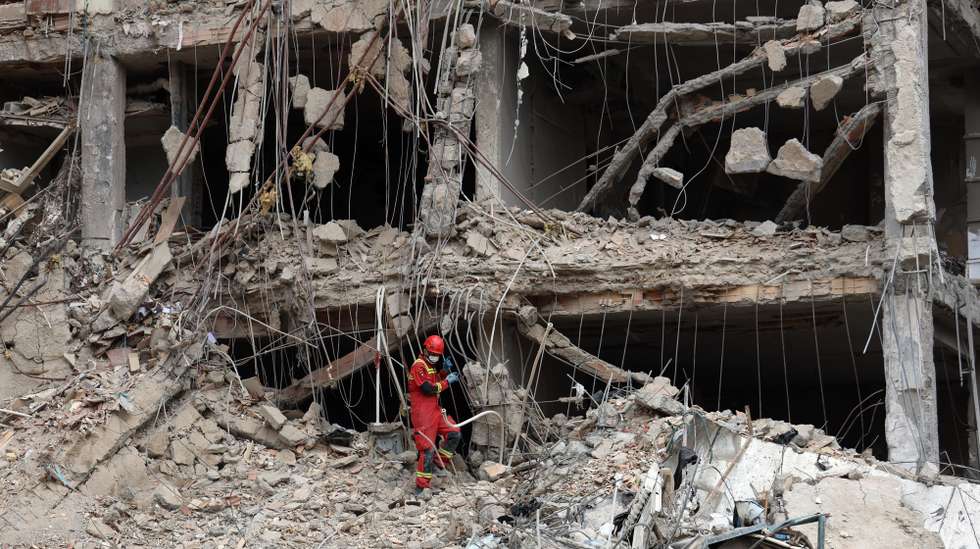epa12843807 Iranian firefighters and officials work at the site of damaged residential buildings in northern Tehran, Iran, 23 March 2026. A joint Israeli and US military operation continues to target multiple locations across Iran since the early hours of 28 February 2026.  EPA/ABEDIN TAHERKENAREH