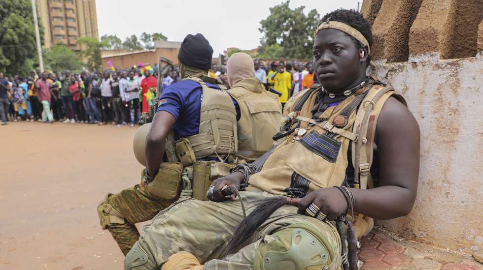 epa10220043 Soldiers sit on a bench during a rally in support of the coup in Ouagadougou, Burkina Faso, 02 October 2022. Thousands of residents came out in support of the coup and protested against France and called for more involvement from Russia. On 01 October, gunshots were heard and the French embassy was set on fire a day after a coup in Ouagadougou. Burkina Faso military Colonel Ibrahim Traore announced on state television 30 September that he had seized power from Lt-Col Paul-Henri Damiba in the coup and alleged Damiba is plotting a counter-attack. In January 2022 Lt-Col Paul-Henri Damiba, ousted President Roch Kabore through a coup.  EPA/ASSANE OUEDRAOGO  EPA-EFE/ASSANE OUEDRAOGO