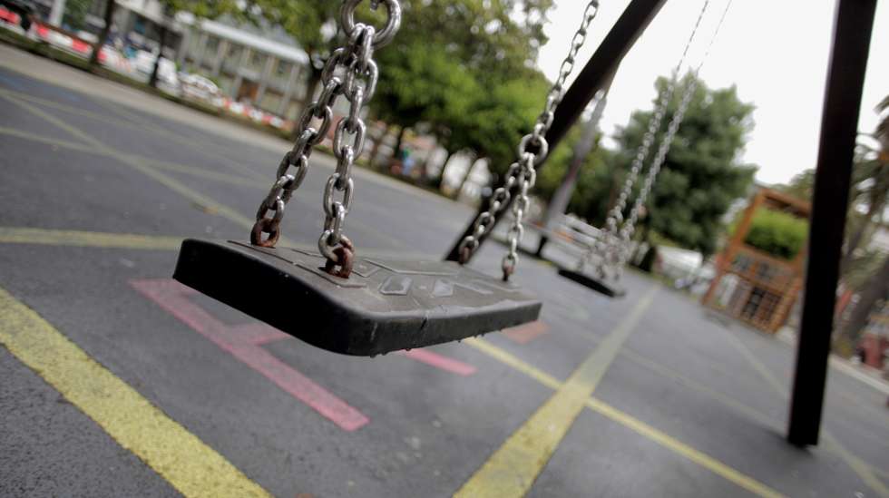 epa08486500 Swings are seen at a playground in A Coruna, Galicia, Spain, where children are finally allowed to use them as the region reaches the 'new normality', 15 June 2020. Galicia is Spain's first region that leaves behind the alarm status to start the so called 'new normality' in which face masks are obligatory in public spaces and common spaces such as playgrounds have a new capacity with a less amount of people to avoid crowded areas.  EPA/Cabalar