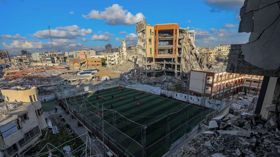 epa12782049 Palestinians play a five-a-side football match on a pitch amid the rubble of heavily damaged buildings, in the Tel al-Hawa neighborhood of Gaza City, 27 February 2026.  EPA/MOHAMMED SABER