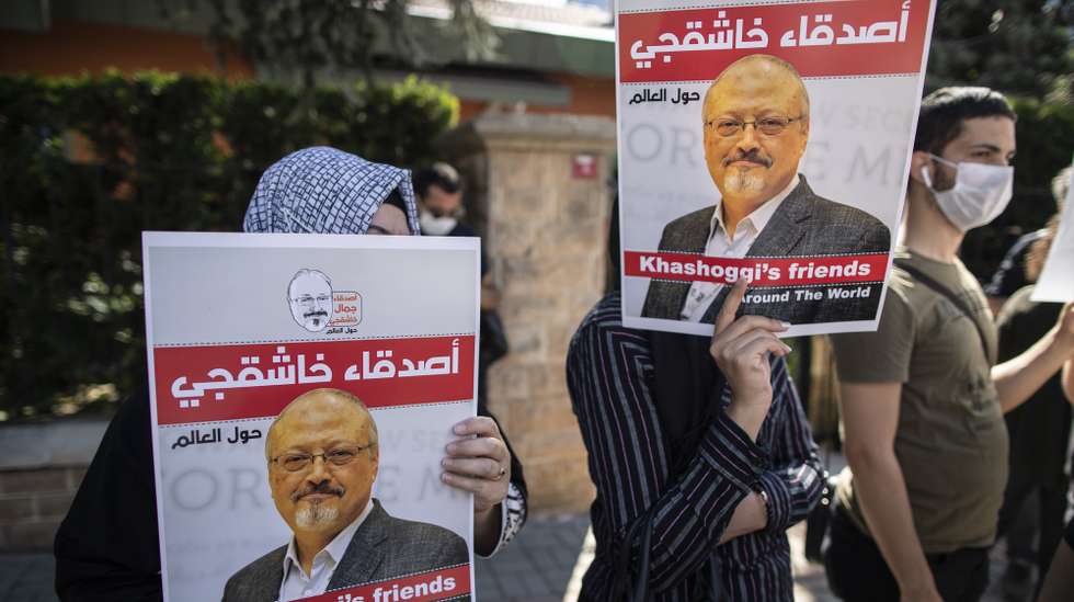 epa08715123 People hold pictures of Jamal Khashoggi during an event marking two-year anniversary of the assassination of Saudi dissident journalist Jamal Khashoggi at the Saudi Consulate in Istanbul, Turkey, 02 October 2020. Saudi dissident journalist Jamal Khashoggi, whose remains have not been found, was assassinated at the Saudi Arabian consulate building in Istanbul on 02 October 2018.  EPA/TOLGA BOZOGLU