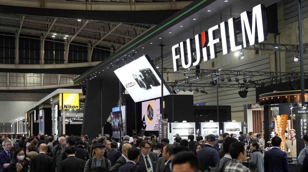 epa11171539 Visitors gather before the Fujifilm booth during the CP+ Camera and Photo Imaging Show in Yokohama, near Tokyo, Japan, 22 February 2024. The CP+ Camera and Photo Imaging Show will be open to the public until 25 February. According to data released by the Camera and Imaging Products Association (CIPA), the total shipments of digital cameras in 2023 were 7,720,505 units or 96.4 percent of the previous year. However, mirrorless cameras reached 4,832,813 units, or 118.6 percent of the total in 2023 compared to the previous year.  EPA/FRANCK ROBICHON