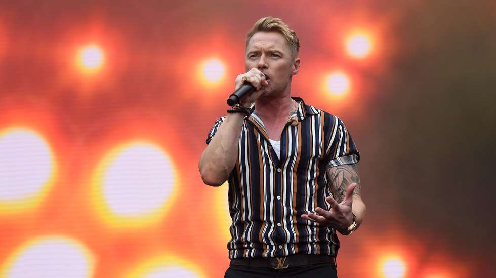 epa08221214 Irish singer Ronan Keating performs on stage during the Fire Fight Australia bushfire relief concert at ANZ Stadium in Sydney, New South Wales, Australia, 16 February 2020. Thousands of people attended the concert, with 10 hours of musical performances, to raise funds for communities devastated by bushfires.  EPA/JOEL CARRETT AUSTRALIA AND NEW ZEALAND OUT
