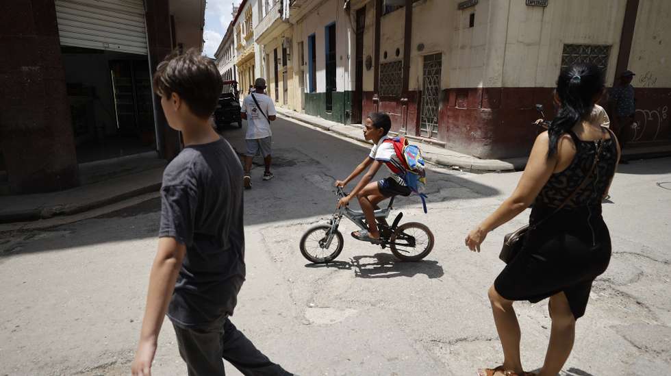 epa13026688 A child rides a bicycle in Havana, Cuba, 05 June 2026 (issued 09 June 2026). With no transportation or food for school cafeterias, the end of the school year has been forced to come early due to the intensifying crisis resulting from the US oil embargo.  EPA/Ernesto Mastrascusa