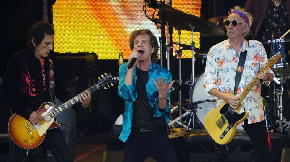 epaselect epa10104472 (L-R) Guitarist Ronnie Wood, lead vocalist Mick Jagger, and guitarist Keith Richards of the British band The Rolling Stones perform, at the Waldbuehne concert venue, in Berlin, Germany, 03 August 2022. The Stones already played venues in Munich and Gelsenkirchen during their 'Sixty' jubilee tour.  EPA/CLEMENS BILAN
