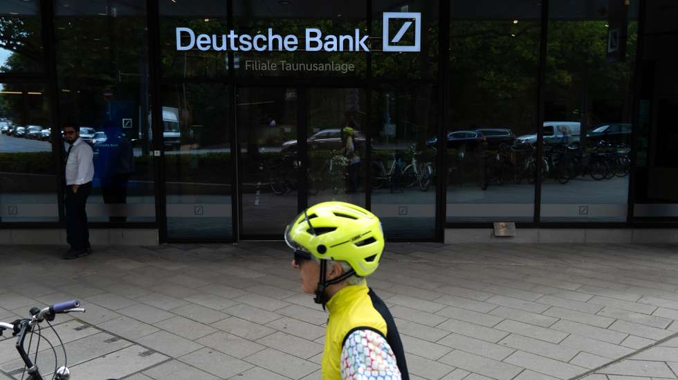 epa13126208 A cyclist parks their bicycle outside the Deutsche Bank central headquarters in Frankfurt, Germany, 22 July 2026. Germany's largest commercial bank, Deutsche Bank, confirmed that its headquarters were searched during an investigation led by the Duesseldorf Public Prosecutor's Office regarding potentially illegal cum-cum transactions involving Postbank between 2008 and 2010.  EPA/MATIAS BASUALDO