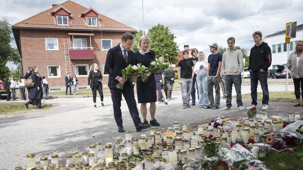 epa13184162 Swedish Prime Minister Ulf Kristersson (L) and Social Democratic Party leader Magdalena Andersson visit the makeshift memorial, one day after an attack carried out by a man with a sword in Fagersta, Sweden, 22 August 2026. A 17-year-old girl was killed and three others were injured at the school after an attack by a man with a sword on 21 August.  EPA/Magnus Lejhall SWEDEN OUT