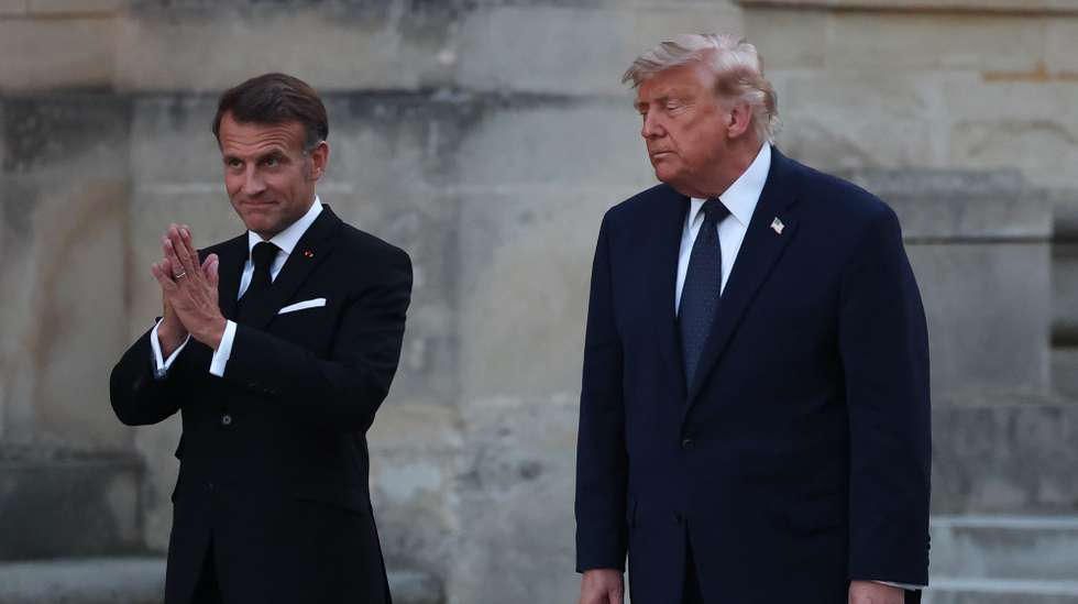 epa13045347 French President Emmanuel Macron (L) and his wife Brigitte Macron (not seen) welcome US President Donald J. Trump (R) at the Palace of Versailles in Versailles, west of Paris, France, 17 June 2026. Macron hosted Trump at Versailles after the G7 summit in Evian-les-Bains.  EPA/MOHAMMED BADRA