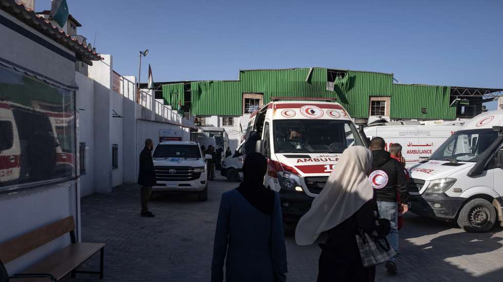epa12888262 Ambulances wait at the Red Crescent headquarters before transporting injured Palestinians toward the Rafah land crossing for transfer abroad to receive medical treatment, in Khan Younis, southern Gaza Strip, 14 April 2026. The WHO said it resumed medical evacuations from Gaza on 12 April after the process was suspended on 6 April following a security incident in which a person contracted to provide services to WHO in Gaza was killed.  EPA/HAITHAM IMAD