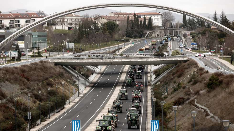 epaselect epa11136615 Farmers drive their tractors as they enter Pamplona after moving by force Civil Guard's vehicles to reach the city of Pamplona, in Navarra region, northern Spain, 08 February 2024. Farmers continue their protests for a third day in a row throughout Spain to demand a relaxation of the environmental demands imposed by the European Union, fairer trade agreements with third countries, reciprocity in food from third countries and aid for crises such as that generated by the drought, echoing demonstrations in other parts of Europe, including Germany, Belgium and France.  EPA/JESUS DIGES