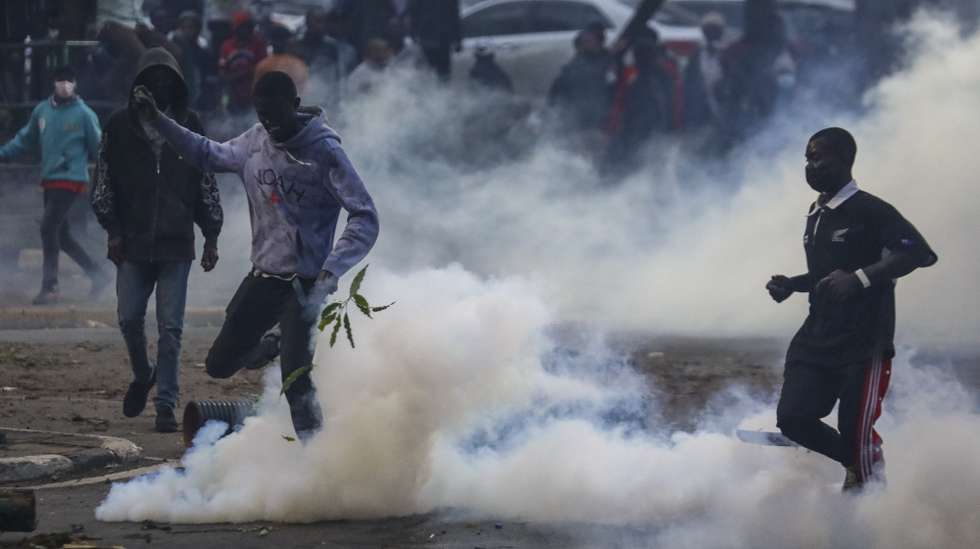 epa11427012 Protesters are teargased as they take part in a demonstration in the evening against a controversial tax bill in the central business district in Nairobi, Kenya, 20 June 2024. Police have fired tear gas to disperse protesters who gathered near the parliament to demonstrate against planned tax hikes that many fear will worsen the cost-of-living crisis.  EPA/DANIEL IRUNGU