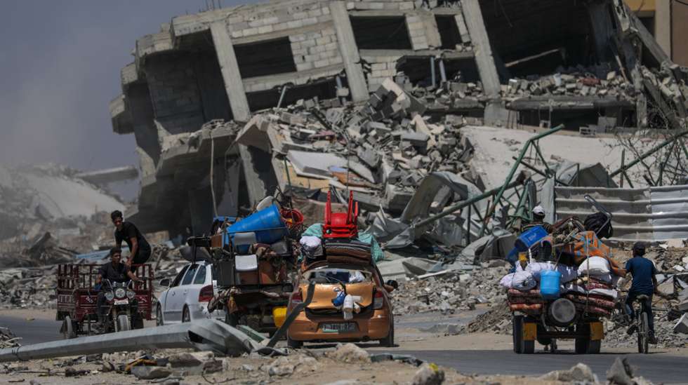 epa11453129 Internally displaced Palestinians leave with their belongings following an evacuation order issued by the Israeli army, in Khan Younis, southern Gaza Strip, 02 July 2024. More than 37,000 Palestinians and over 1,455 Israelis have been killed, according to the Palestinian Health Ministry and the IDF, since Hamas militants launched an attack against Israel from the Gaza Strip on 07 October 2023, and the Israeli operations in Gaza and the West Bank which followed it.  EPA/MOHAMMED SABER