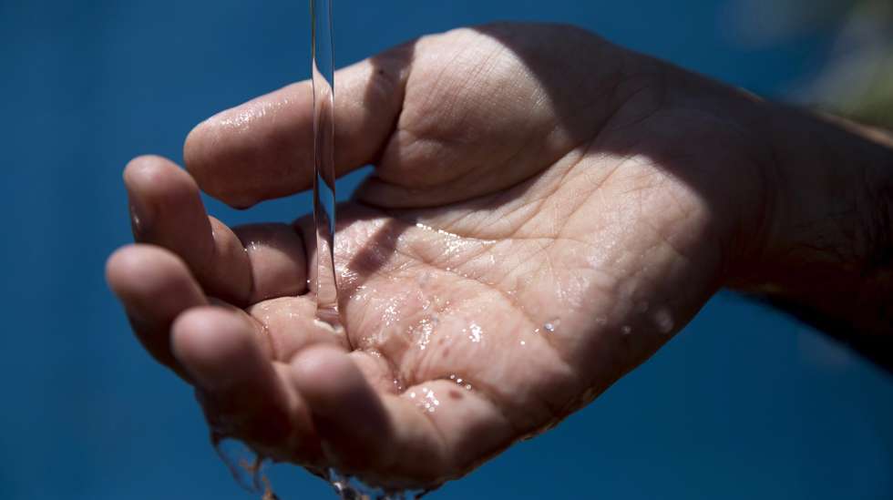 epa06820857 A worker of Hadera seawater desalination plant checks the desalinated sea water in Hadera, Israel, 19 June 2018. After five years of drought and insufficient water flowing from the Jordan River into the freshwater lake Sea of Galilee, the Israeli government approved a project plan to pump 100 million cubic metres of desalinated seawater annually by 2022 into the Sea of Galilee. Desalinated water already makes 70 percent of Israel's tap water. Christians believe Jesus walked on water over Sea of Galilee inland lake.  EPA/ABIR SULTAN