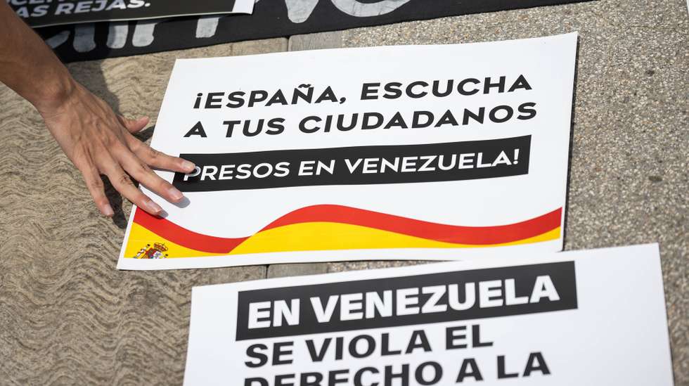 epa12381124 A person organizes posters during a rally for political prisoners in front of the Spanish embassy in Caracas, Venezuela 15 September 2025. The NGO Committee for the Freedom of Political Prisoners asked Spain to use its 'influence and leadership' to promote the release of political prisoners in Venezuela through 'diplomatic channels.'  EPA/RONALD PENA R