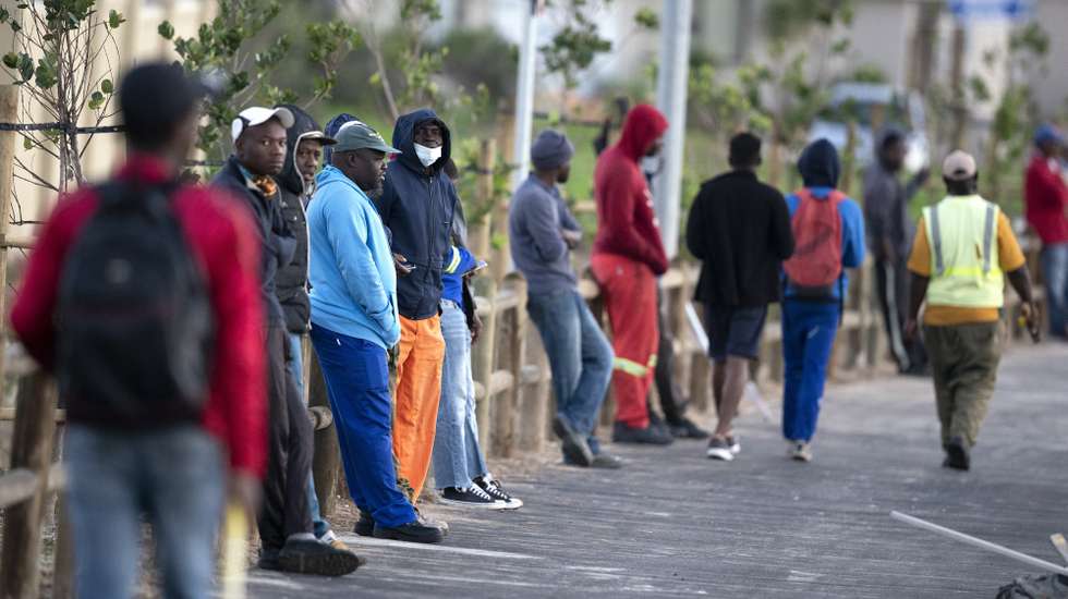 epa08508009 Men wait for work in the informal sector with around 200 other job seekers at a road junction in Cape Town, South Africa, 24 June 2020 (issued 25 June 2020). According to a report released this week by Statistics South Africa the unemployment rate has reached a record high level of 30.1 percent up from 29.1 percent in the final quarter of last year. Africa's biggest economy was in recession before the coronavirus pandemic but lockdowns have further negatively impacted businesses and employment opportunities. The informal sector provides employment to approximately 30 percent of South African workers according to the World Bank. Cape Town is the countries epicenter of coronavirus SARS-CoV-2 which causes the Covid-19 disease.  EPA/NIC BOTHMA ATTENTION: This Image is part of a PHOTO SET