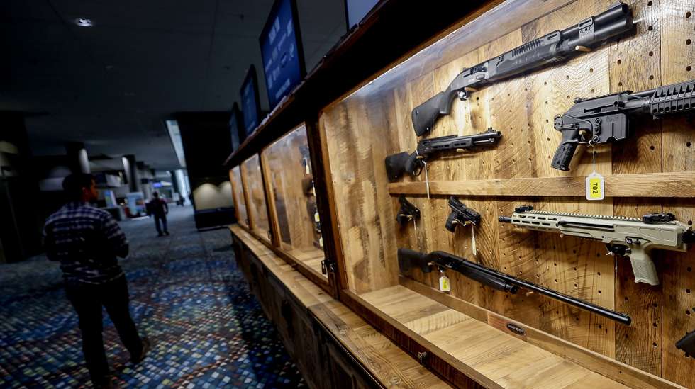 epa12052306 A person passes the 'Wall of Guns' display during setup for the National Rifle Association (NRA) 154th Annual Meeting and Exhibits in Atlanta, Georgia, USA, 24 April 2025. The 2025 NRA annual meeting takes place at the Georgia World Congress Center from 24 to 27 April.  EPA/ERIK S. LESSER