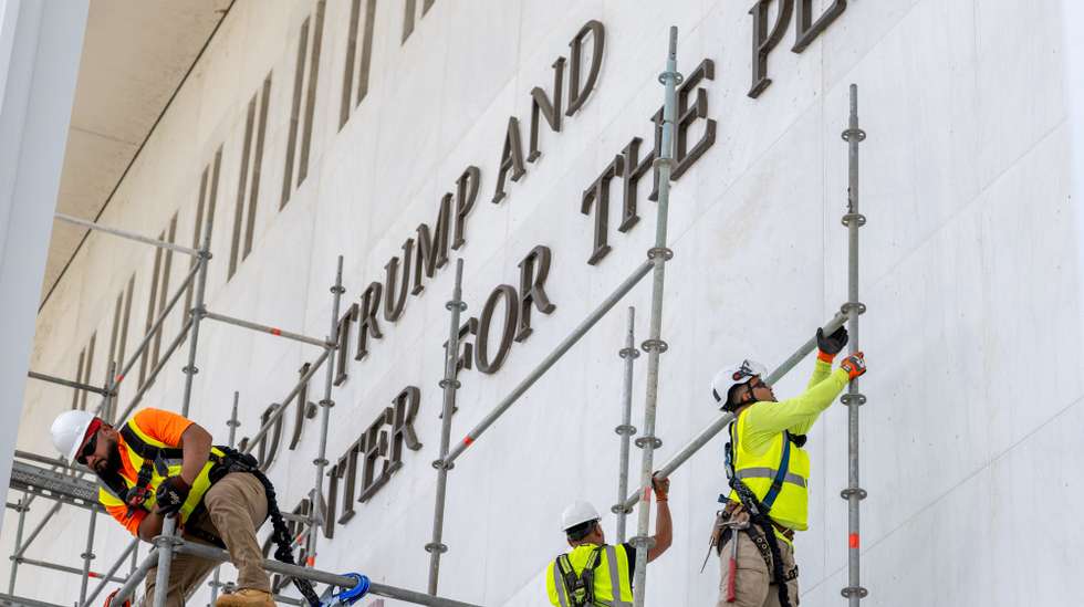 epa13033932 Workers prepare to remove the name of US President Donald J. Trump from the facade of the John F. Kennedy Center for the Performing Arts in Washington, DC, USA, 12 June 2026. The removal comes after a federal judge ruled that the name had been added illegally.  EPA/MATT KAMINSKY
