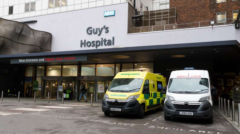 epa08869849 Ambulances are parked outside Guy's Hospital in London, Britain, 08 December 2020. Margaret Keenan, 90, became the first person in the UK to receive the Pfizer-BioNTech COVID-19 vaccine, and NHS hospitals across Britain will now start to roll out the Pfizer BioNTech COVID-19 vaccine.  EPA/VICKIE FLORES