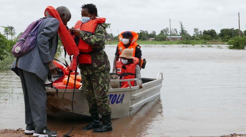 People prepare to cross the Umbeluzi river in a motorboat belonging to the Mozambican armed forces that are providing support to the population, due to heavy rains in recent days, leaving underwater the bridge linking the district headquarters, the town of Boane, 40 kilometers from the capital, Maputo, Mozambique, 16 February 2021. The forecasts point to an improvement of atmospheric conditions in the south of the country from Wednesday, without rain and with the return of the sun. LUISA NHANTUMBO/LUSA