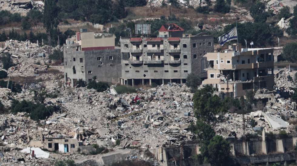 epaselect epa13070679 An Israeli flag waves atop a destroyed house in the southern Lebanese village of Meiss al-Jabal, as seen from the Israeli side of the border in the Upper Galilee, northern Israel, 28 June 2026, amid an Israel-Lebanon ceasefire.  EPA/ATEF SAFADI