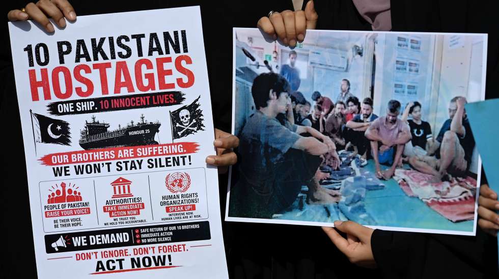 epa12953974 Relatives of Pakistani nationals stranded in Somalia hold placards and photos of their loved ones during a protest near Karachi Port Trust (KPT) in Karachi, Pakistan, 13 May 2026. Families appealed to the Pakistani government and international bodies for urgent action as concerns grow over individuals reportedly held under unclear circumstances, including crew members linked to the hijacked oil tanker 'MT Honour 25'.  EPA/SHAHZAIB AKBER