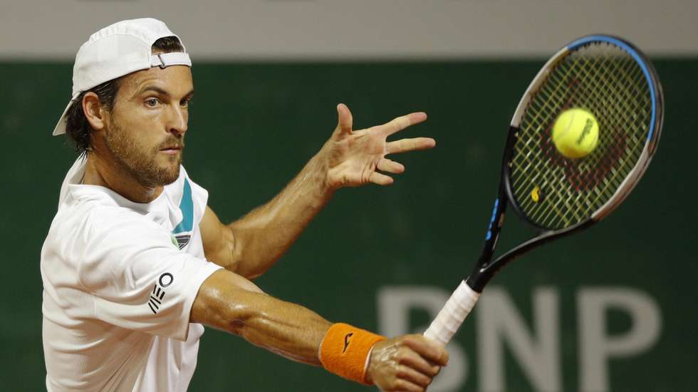 epa08706516 Joao Sousa of Portugal hits a backhand during his first round match against Andrej Martin of Slovakia at the French Open tennis tournament at Roland Garros in Paris, France, 29 September 2020.  EPA/YOAN VALAT