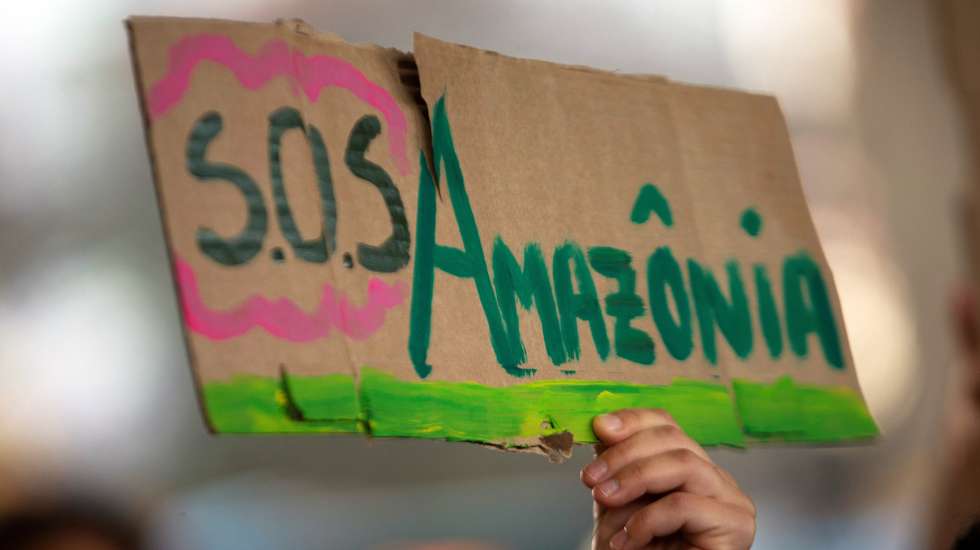 epa07821187 A protester holds a banner 'SOS Amazon'  during a protest in the framework of the Amazon Day in Brasilia, Brazil, 05 September 2019. Brazil celebrates the Amazon Day amid multiple fires that ravaged the Rainforest, the increase of the deforestation and the 'anti-environmental' rhetoric of President Jair Bolsonaro.  EPA/JOEDSON ALVES