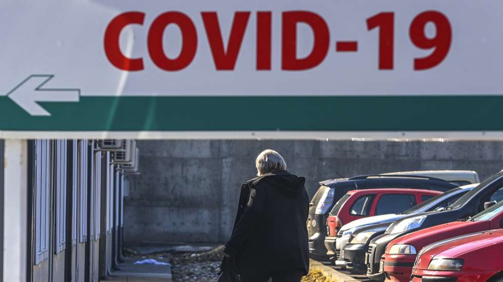epa08986637 A woman walks in front of the University Clinic for Infectious Diseases in Skopje, Republic of North Macedonia, 04 February 2021. Three cases of the Britsh coronavirus mutation were confirmed so far in North Macedonia. One of the infected passed away. In the last two weeks the new coronavirus cases have failed and the government was planning to further ease some of the restrictions, but the British mutation appearance halted the process.Since the start of the pandemics there are close to 92,000 confirmed cases of Covid-19 in North Macedonia while the number of deaths reaches around 2,830. AstraZeneca and Pfizer vaccines are still not available, the government reached a direct agreement with Chinese Sinovac for 200,000 units of its CoronaVac vaccine. Health Minister Venko Filipche stressed that they are expected to arrive in February 2021. EPA/GEORGI LICOVSKI