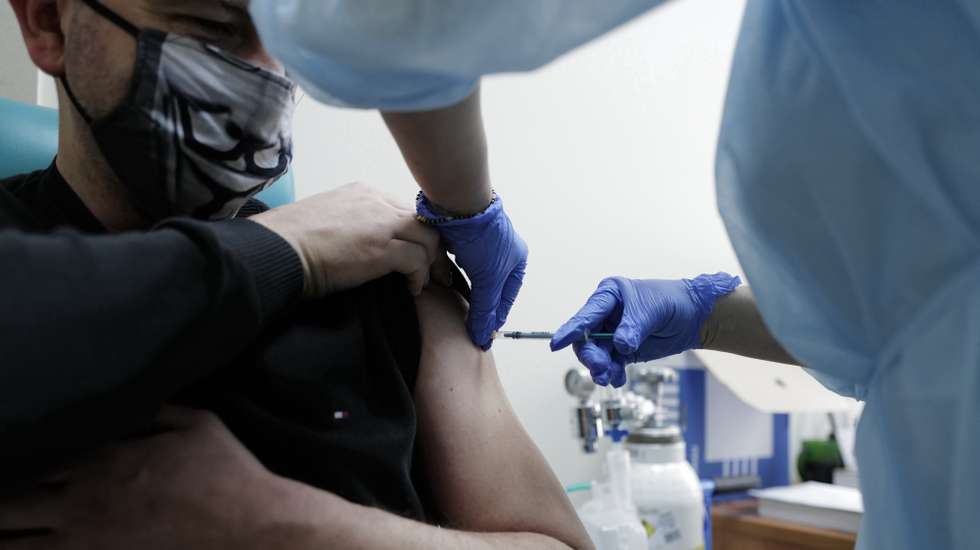 epa09006596 A teacher receives the Astra Zeneca COVID-19 vaccine at the Municipal Hospital in Sosnowiec, southern Poland, 12 February 2021. Poland received 141,000 doses of the AstraZeneca vaccine and 82,000 Moderna vaccines on 11 February. The Moderna vaccine is earmarked for the general population while the AstraZeneca shots are for teachers, who start to be vaccinated from 12 February.  EPA/Andrzej Grygiel POLAND OUT