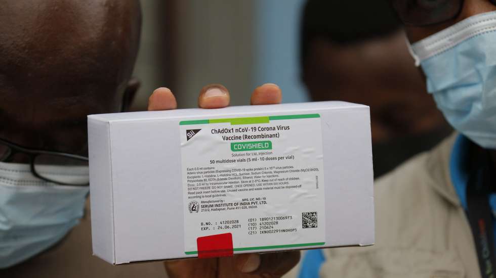 epa09034893 A handout photo made available by UNICEF showing a staff member displays a box containing 50 5ml vials of COVID-19 vaccines, part of the first shipment of COVID-19 vaccines distributed by the COVAX Facility in Accra, Ghana, 24 February 2021. The shipment with 600,000 doses of the vaccine also represents the beginning of what should be the largest vaccine procurement and supply operation in history. The COVAX Facility plans to deliver close to 2 billion doses of COVID-19 vaccines this year. This is an unprecedented global effort to make sure all citizens have access to vaccines.  EPA/Kofi Acquah / UNICEF / HANDOUT MANDATORY CREDIT HANDOUT EDITORIAL USE ONLY/NO SALES