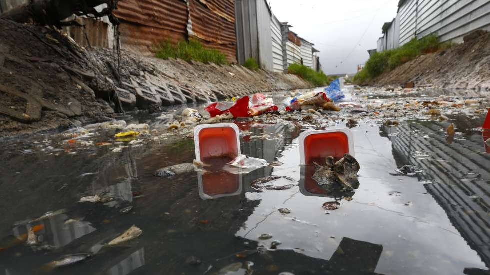 epa06602747 A general view of garbage in a highly polluted river next to shack homes in Masiphumelele, Cape Town, South Africa, 14 March 2018. Rapid urbanization and a national government that has not provided enough infrastructure in high density neighborhoods like Masiphuumelele are two of the major factors environmentalists cite contributing to the polluting of urban rivers. Environmental activists globally observe on 14 March annually the International Day of Action for Rivers with the aim of raising awareness around issues concerning the world's water ways.  EPA/NIC BOTHMA
