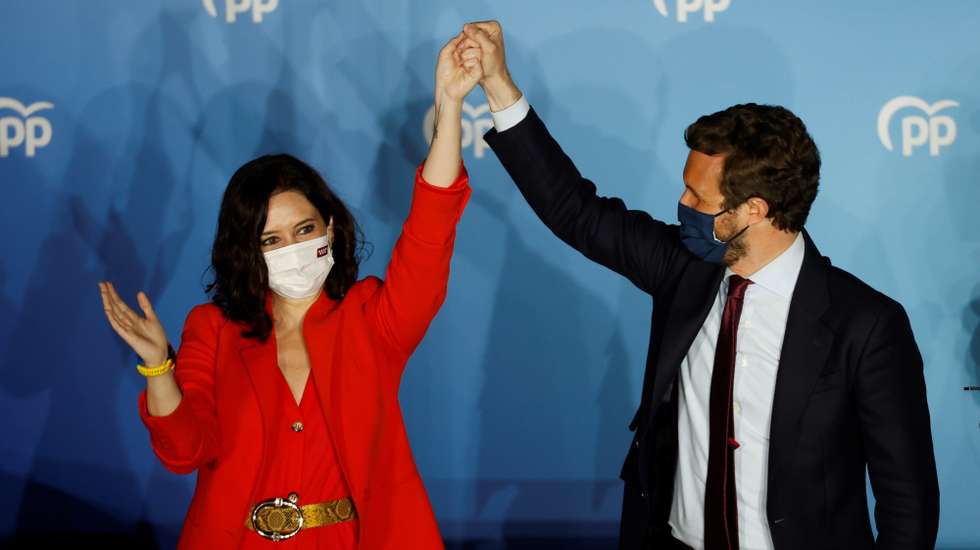 epa09177947 Madrid's regional president and candidate to reelection Isabel Diaz Ayuso (L) and People's Party Part Leader Pablo Casado react as they wait for Madrid's regional elections results closing to the party's headquarters in Madrid, central Spain, 04 May 2021. Isabel Diaz Ayuso could be reelected with between 62 and 65 deputies but would need the support of far-right Vox to form a governmet, according Spanish media.  EPA/Mariscal
