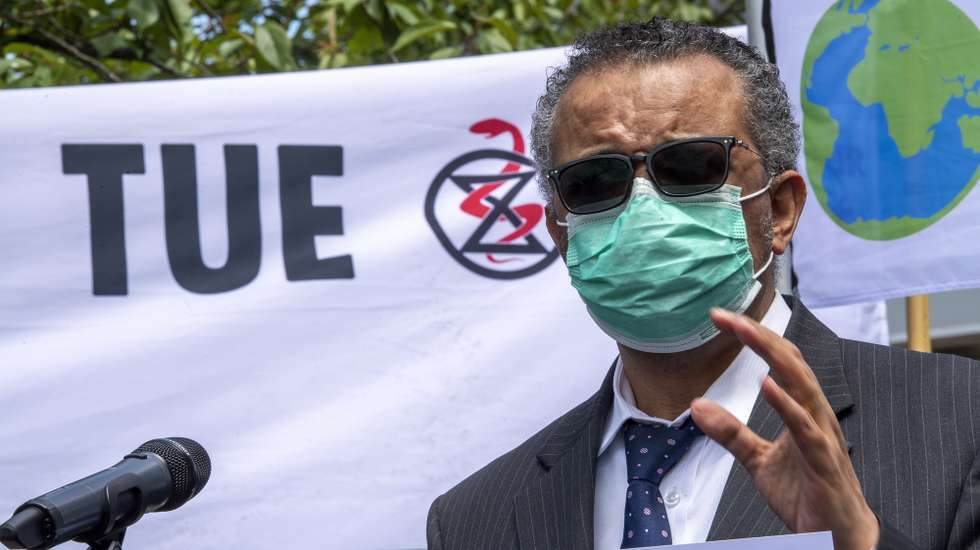 epa09234907 Director General of the World Health Organization (WHO), Tedros Adhanom Ghebreyesus meets members of the Doctors for Extinction Rebellion (XR) collective during a protest in front of the WHO headquarters on the sideline of the WHO's World Health Assembly in Geneva, Switzerland, 29 May 2021. Hundreds of health workers marched to the WHO demanding that authorities in all countries recognize and act to counter the health risks of climate change.  EPA/MARTIAL TREZZINI