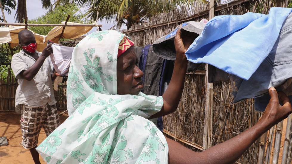 epa09133249 Ubaia Ureli (R) and his wife Mungui Anli (L) lost contact with the rest of their family during the conflicts and live in a house with 3 other family members, all displaced from Palma, borrowed from a family friend, Pemba, Mozambique, 13 April 2021. Armed violence in Cabo Delgado began more than three years ago, but escalated again two weeks ago when armed groups first attacked the village of Palma, which is about six kilometers from the multimillion-dollar natural gas projects.  EPA/JOAO RELVAS