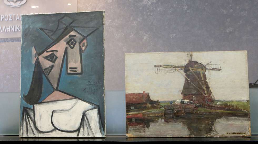epa09310222 The stolen Picasso and Mondrian paintings, at a press conference, in Athens, Greece, 29 June 2021. The Greek police have recovered Pablo Picasso’s 'Head of a Woman' and Piet Mondrian’s 'Stammer Windmill', which had been stolen from the National Gallery in Athens in 2012. Police found the two paintings hidden in a gorge in Keratea, east Attica on Monday 28 June 2021. A 49-year-old man has been arrested.The perpetrators also removed an early 17th-century sketch attributed to the Italian Mannerist artist Guglielmo Caccia.  EPA/PANTELIS-SAITAS