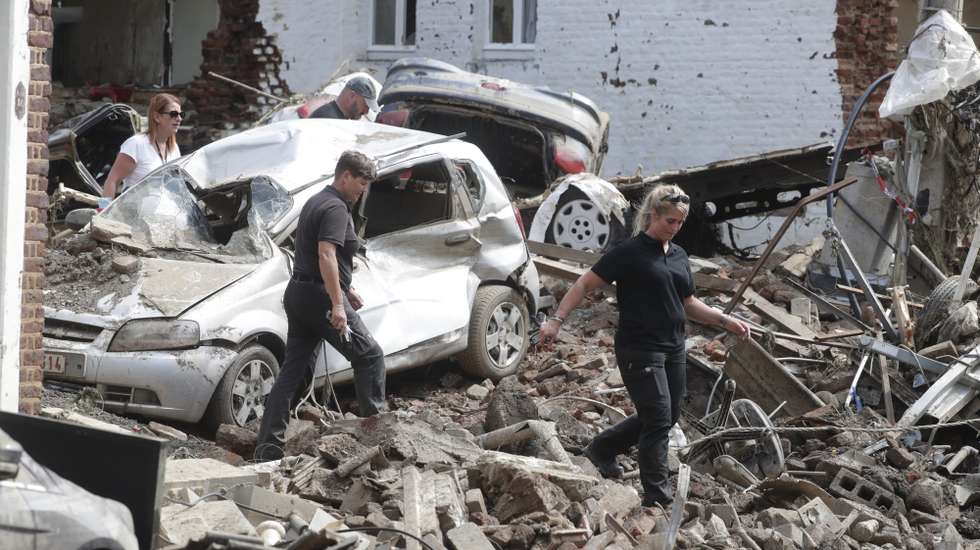 epa09353281 Members of the Belgium Federal Police with a sniffer dog search for bodies in the rubble after heavy rains caused flooding in Pepinster, Belgium, 19 July 2021. Heavy rains have caused widespread damage and flooding in parts of Belgium in the night of 14/15 July.  EPA/STEPHANIE LECOCQ