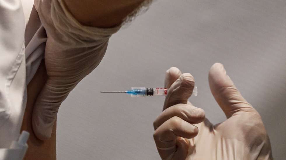 epa09419469 A woman receives a shot of Pfizer vaccine against COVID-19 disease at a vaccination center in Tbilisi, Georgia, 18 August 2021. Georgia reported 5,914 coronavirus cases, and 49 deaths on 18 August. US President Joe Biden donated 500,000 doses of US-German vaccine Pfizer to Georgia, the Ministry of Labor, Health and Social Affairs of Georgia reports. This drug is enough to vaccinate 250 thousand citizens. In Georgia, only 1.5 percent were fully vaccinated. China has supplied 1.5 million Sinovac and Sinofarm vaccines to Georgia.  EPA/ZURAB KURTSIKIDZE