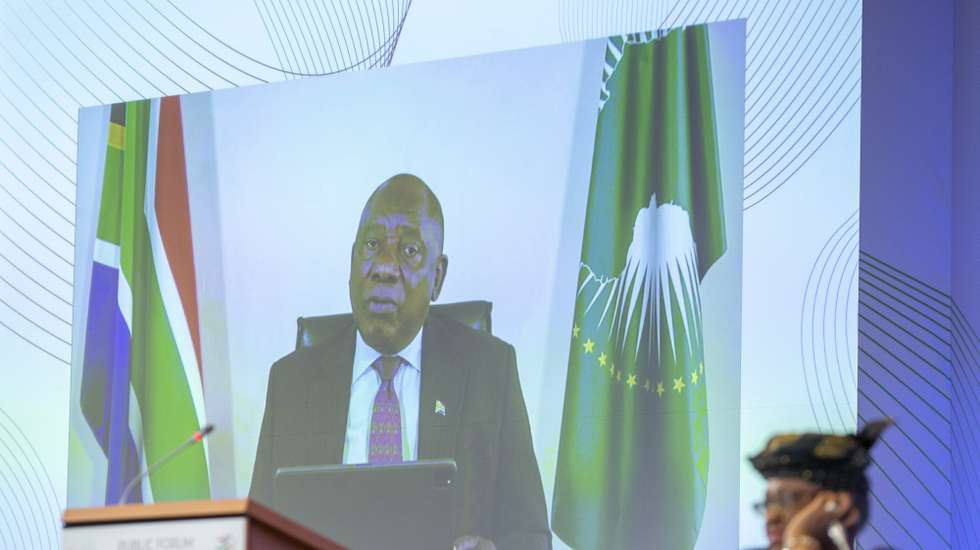 epa09492707 President of South Africa Cyril Ramaphosa is seen on a screen as he delivers his speech past Nigeria's Ngozi Okonjo-Iweala (R), Director General of the World Trade Organisation (WTO), during the opening of the WTO Forum Public on Trade Beyond COVID-19: Building Resilience, at the headquarters of the World Trade Organization (WTO) in Geneva, Switzerland, 28 September 2021.  EPA/SALVATORE DI NOLFI