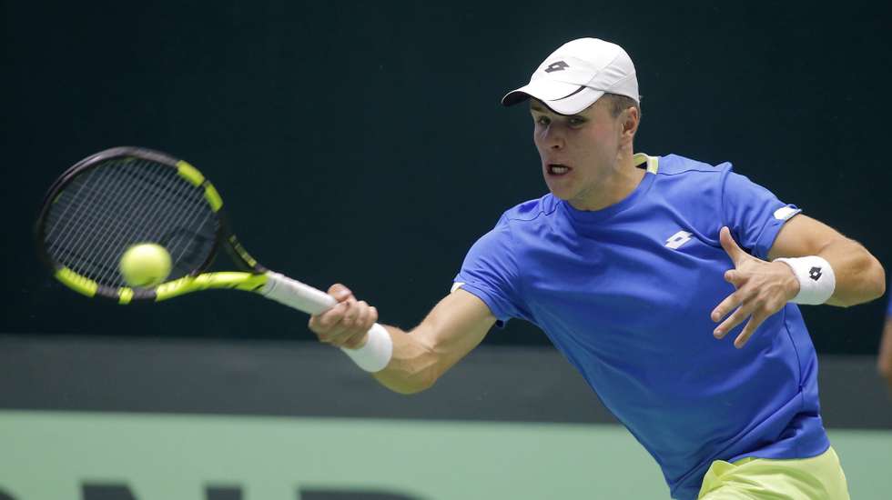 epa06491223 Dmitry Popko of Kazakhstan in action against  Henry Laaksonen of Switzerland during their Davis Cup Final match in Astana, Kazakhstan, 02 February 2018.  EPA/IGOR KOVALENKO