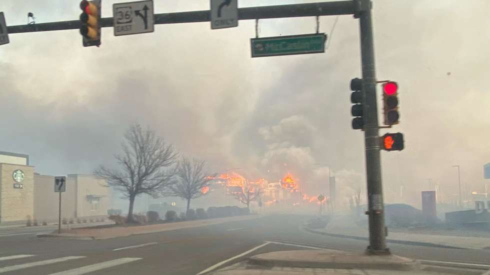 epa09661069 A handout photo made available by the Broomfield Police Department and taken by a patrol officers shows smoke and flames seen from McCaslin Blvd east of US 36 in Superior, Boulder County, Colorado, USA, 30 December 2021. Fast-moving wildfires, the Marshall and Middle Fork fires, on 30 December forced the evacuation of thousands of people in the towns of Louisville and Superior in Boulder County, Colorado. 'The fire activity is constantly changing and highly impacted by the weather,' the Boulder Office of Emergency Management (OEM) said in a statement.  EPA/BROOMFIELD POLICE DEPARTMENT HANDOUT -- BEST QUALITY AVAILABLE -- HANDOUT EDITORIAL USE ONLY/NO SALES