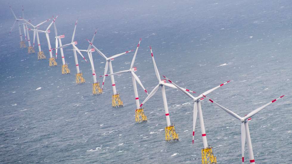 epa04929486 A picture made available on 14 September 2015 shows an aerial view of a row of wind turbines in the Offshore Windpark 'Nordsee-Ost' off the North Sea island of Sylt, Germany, 04 September 2015.  EPA/Daniel Reinhardt