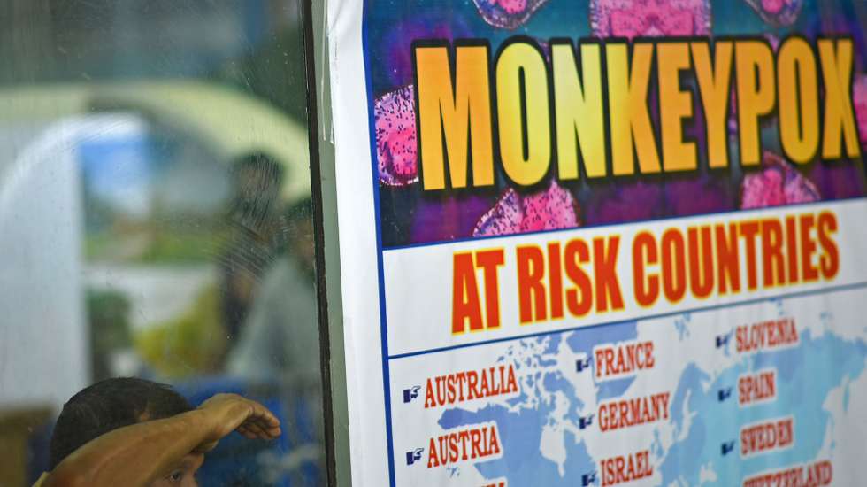 epa10334191 (FILE) - A security personnel looks on next to a list of high-risk countries for the Monkeypox virus, at Chennai International Airport, in Chennai, India, 16 July 2022 (reissued 28 November 2022). The World Health Organization (WHO) in a statement on 28 November 2022 said it "will begin using a new preferred term mpox as a synonym for monkeypox" simultaneously for one year until the term 'monkeypox' is phased out. The decsion was taken after consultations with global experts as "racist and stigmatizing language online, in other settings and in some communities was observed and reported to WHO."  EPA/IDREES MOHAMMED