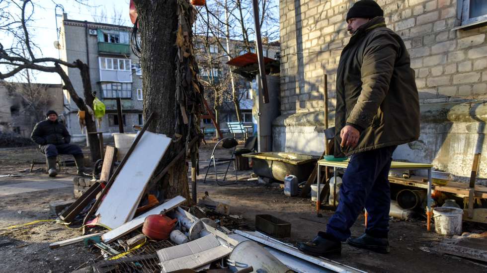 epa10424932 Locals stand by the cluster from a Uragan missile in the yard of a residential building in Siversk town  Donetsk region, eastern Ukraine, 23 January 2023.  Russian troops entered Ukraine on 24 February resulting in fighting and destruction in the country and triggering a series of severe economic sanctions on Russia by Western countries.  EPA/OLEG PETRASYUK