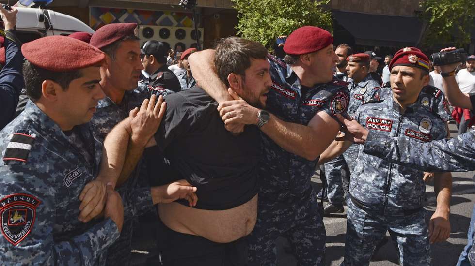 epa10876478 Armenian policemen detain a man during a protest against Azerbaijan's military action in the Nagorno-Karabakh region, in Yerevan, Armenia, 22 September 2023. More than 80 people were detained at anti-government rallies in Yerevan, the Armenian Police reported. On 19 September, after the start of the military operation of the Azerbaijani Armed Forces in Nagorno-Karabakh, opposition protests began in Armenia demanding the resignation of Prime Minister Nikol Pashinyan. A national committee has been created that coordinates actions to remove Pashinyan and his government from power. Representative of the Dashnaktsutyun party Ishkhan Saghatelyan said that the parliamentary opposition is also initiating the process of impeachment of Pashinyan.  EPA/NAREK ALEKSANYAN