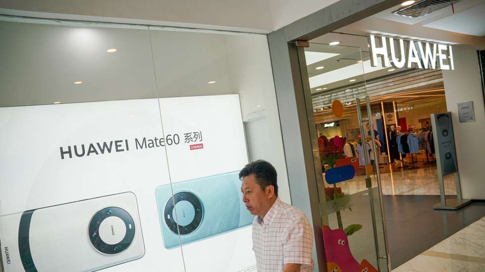 epa10861461 A man walks beside a Huawei store in Beijing, China, 15 September 2023. According to the data released by the National Bureau of Statistics (NBS) on 15 September, China's retail sales increased by 4.6 percent year-on-year in August 2023, accelerating from a 2.5 percent growth in July and exceeding market estimates of 3.0 percent.  EPA/WU HAO