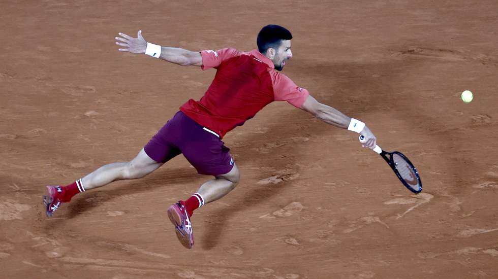 epa11376397 Novak Djokovic of Serbia in action during his Men's Singles 1st round match against Pierre-Hugues Herbert of France at the French Open Grand Slam tennis tournament at Roland Garros in Paris, France, 28 May 2024.  EPA/MOHAMMED BADRA