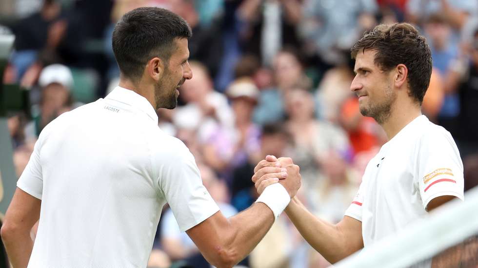epa11452859 Novak Djokovic (L) of Serbia is congratulated at the net by Vit Kopriva of the Czech Republic after winning their Men's 1st round match at the Wimbledon Championships, Wimbledon, Britain, 02 July 2024. Djokovic won in three sets.  EPA/NEIL HALL  EDITORIAL USE ONLY